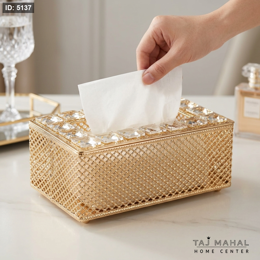 A rectangular tissue encrusted with crystal pieces and golden geometric patterns