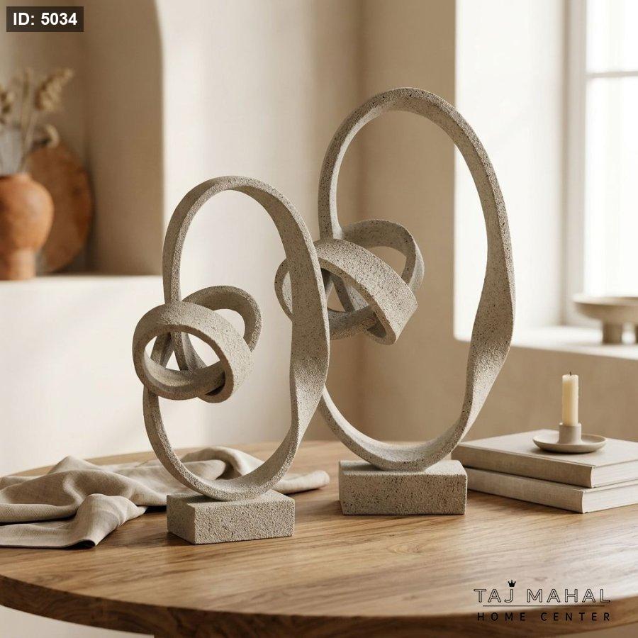 Abstract resin decorative figurine with interlocking spiral knot design