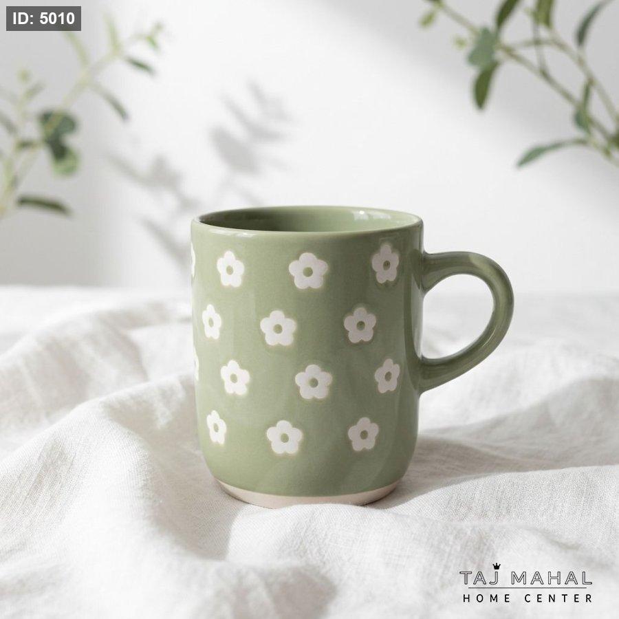 Green porcelain mug with white floral pattern