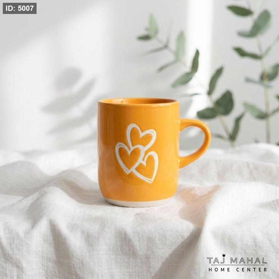 Yellow porcelain mug with white hearts