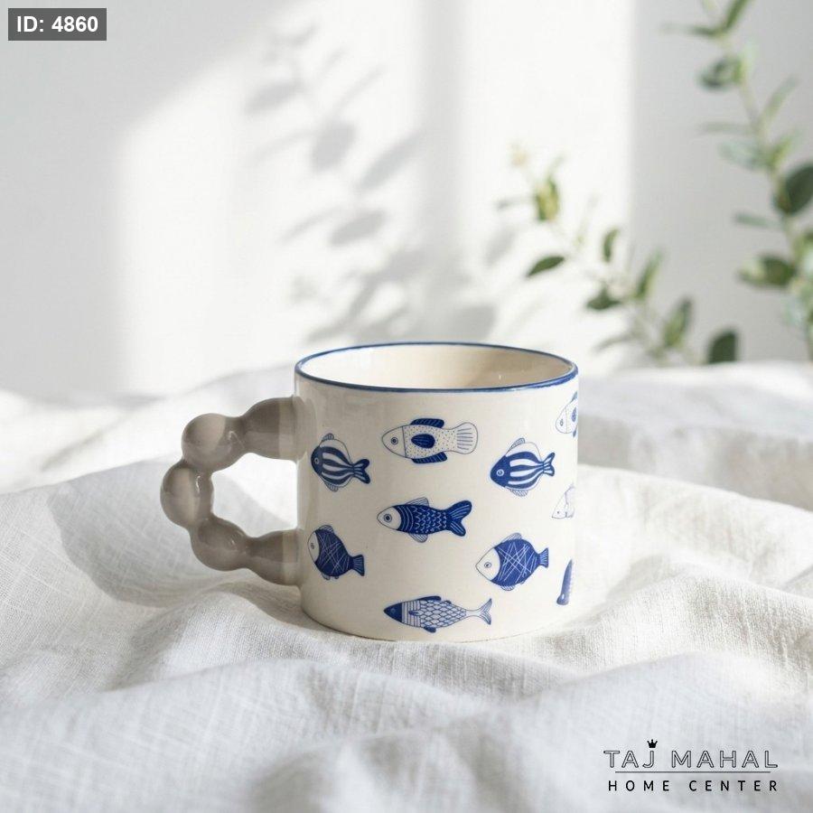 White ceramic mug with cute blue drawings