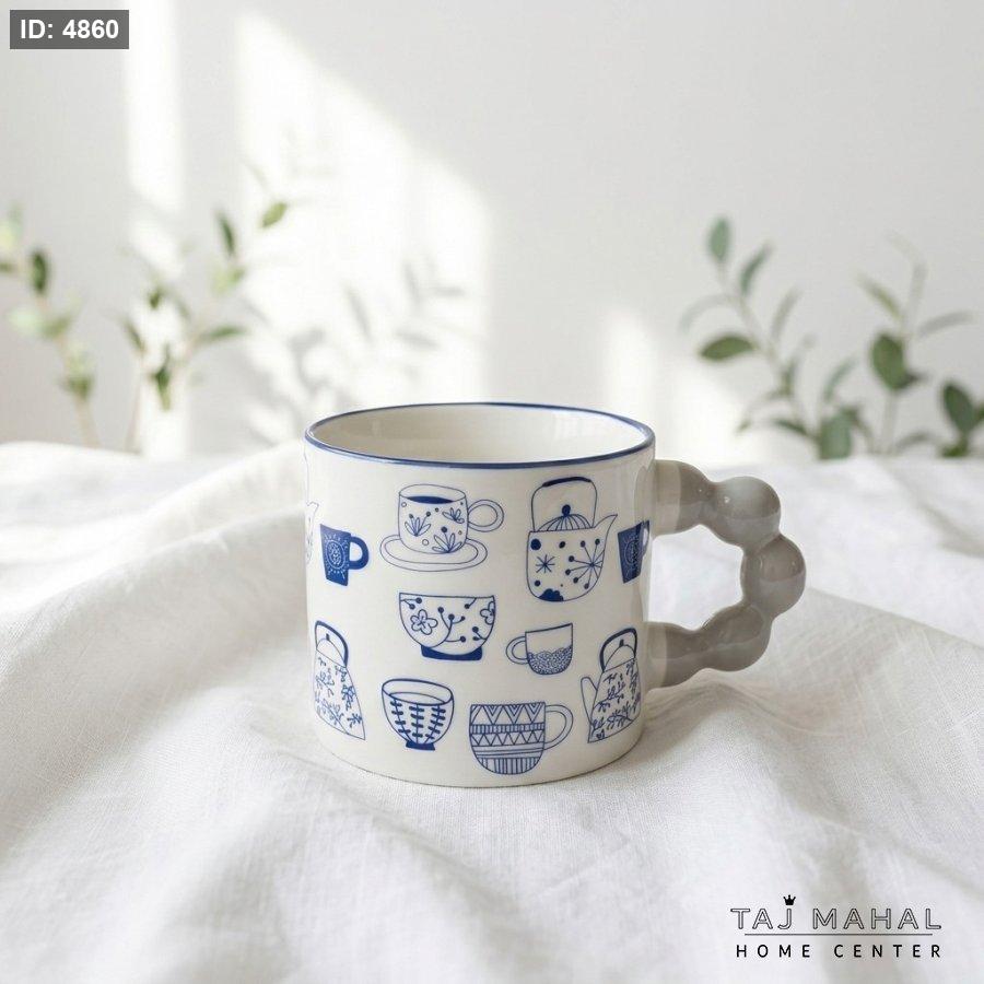 White ceramic mug with cute blue drawings