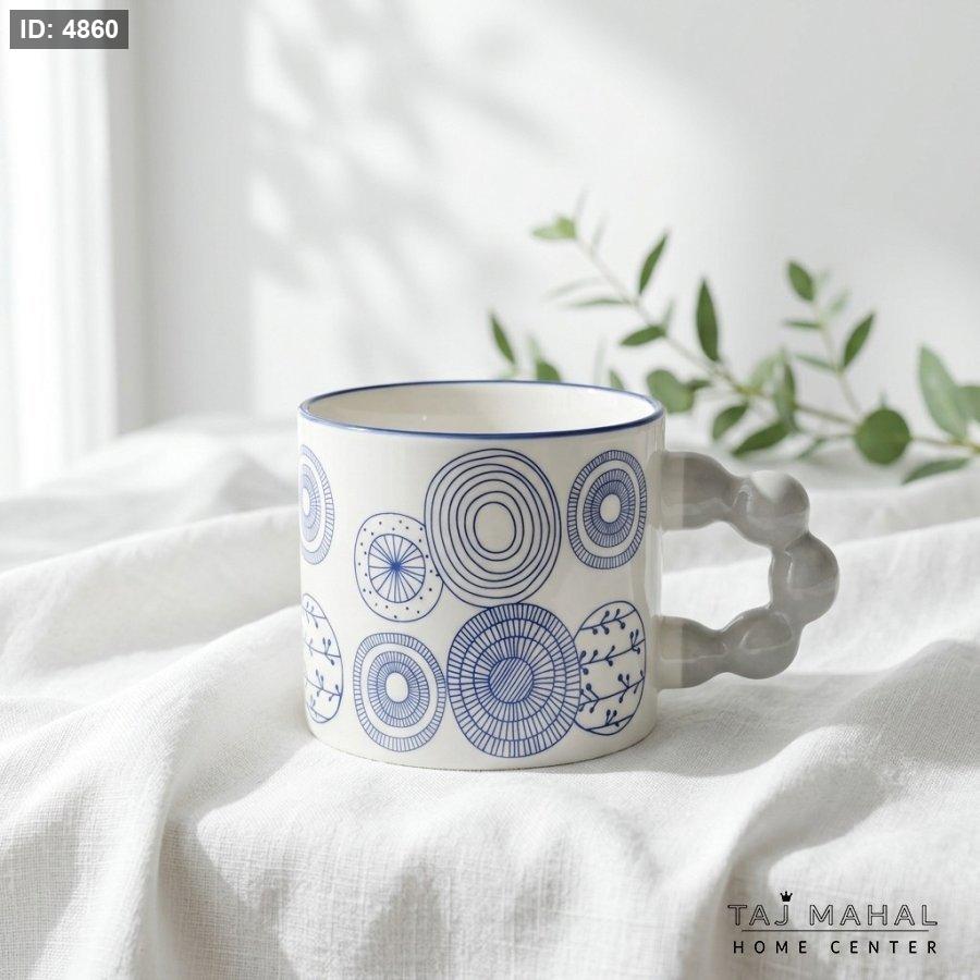 White ceramic mug with cute blue drawings