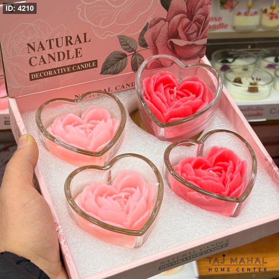 Rose-shaped scented candles inside a heart-shaped glass