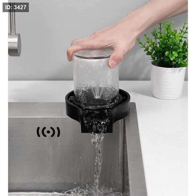 Automatic washing base for rinsing bottles, cups and kitchen sink supplies